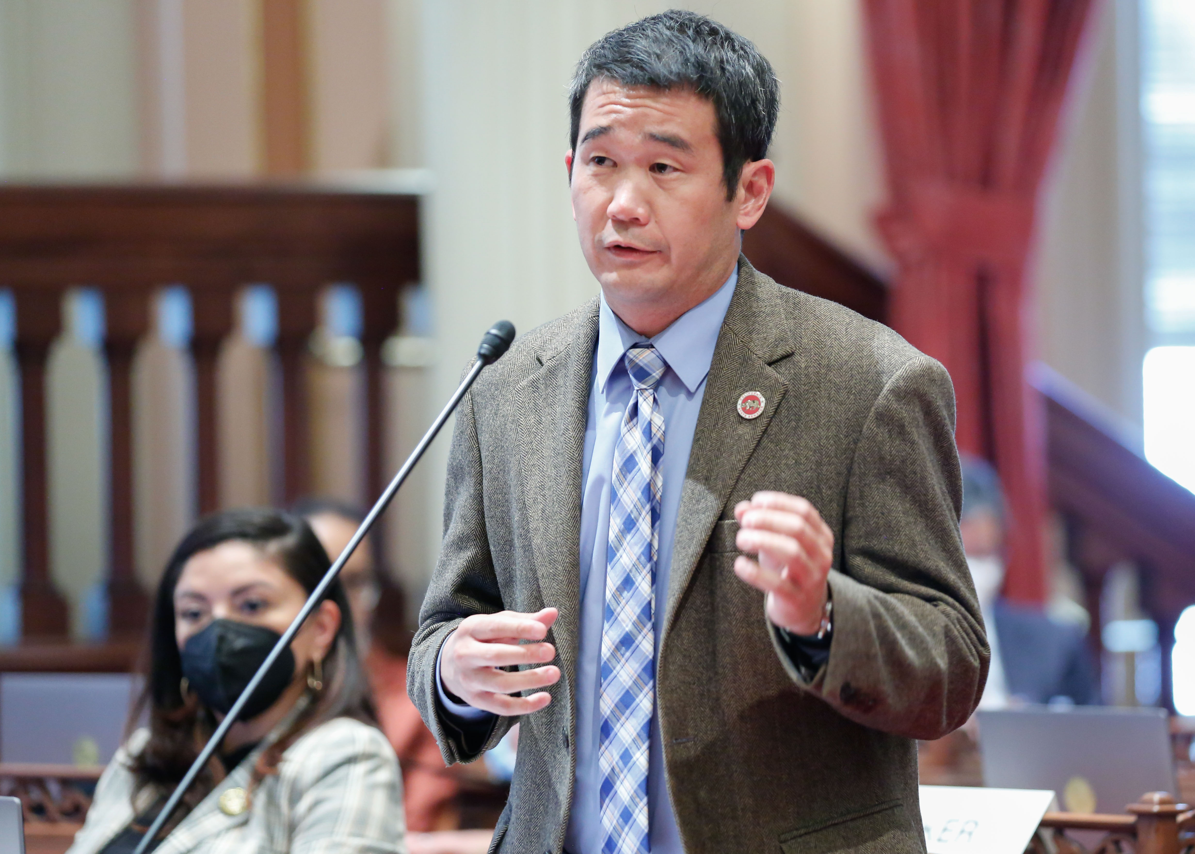 Senator Dave Min on the floor of the California State Senate.